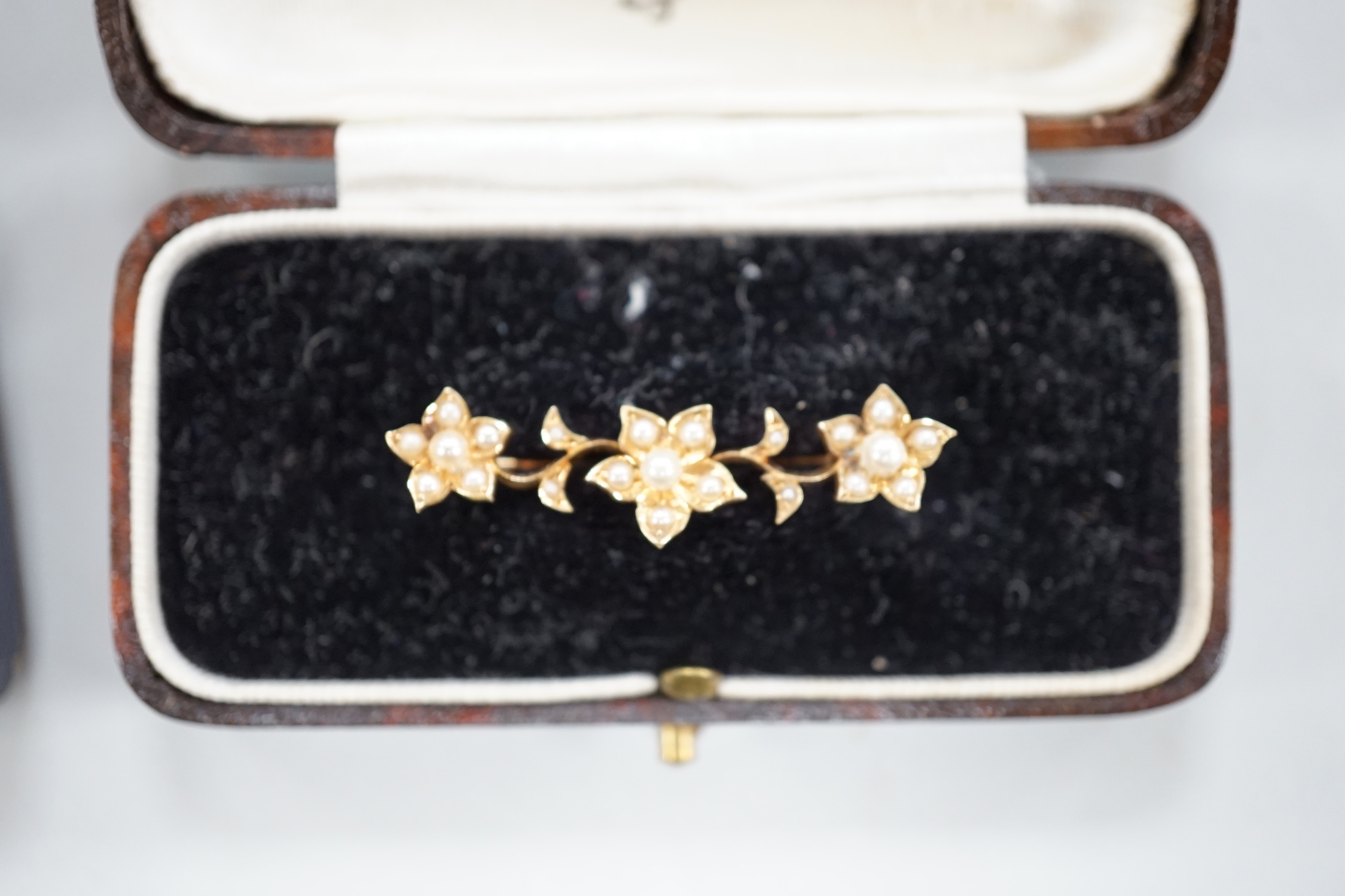 An Edwardian 15ct gold and seed peal set heart drop bar brooch, 40mm, gross weight 2.7 grams, two other yellow metal and gem set bar brooches and a Victorian citrine set brooch.